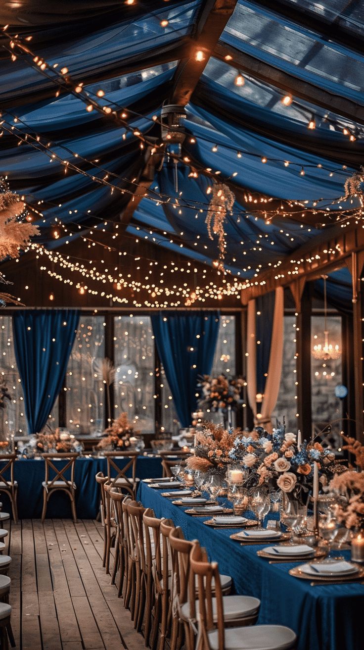 an indoor dining area with blue drapes and lights