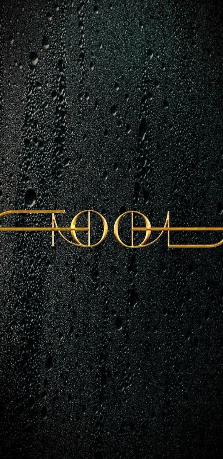 the word aoop written in gold on a black surface with drops of water around it