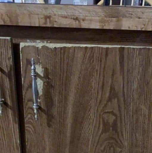 a close up of a wooden cabinet with knobs