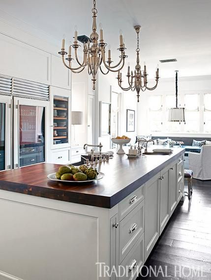 a large kitchen with an island and chandelier