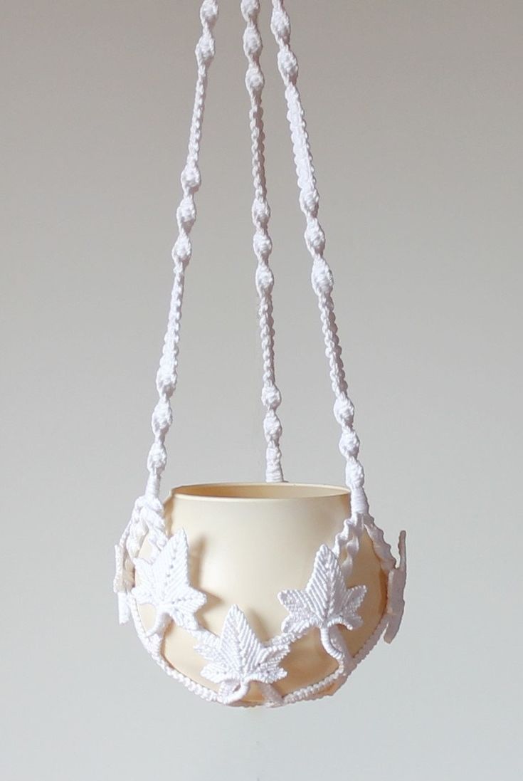 a white bowl hanging from a chain