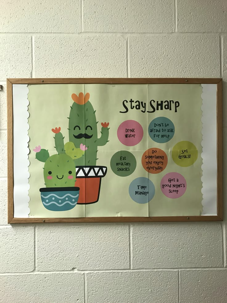 a bulletin board hanging on the wall next to a potted plant with words that say stay sharp