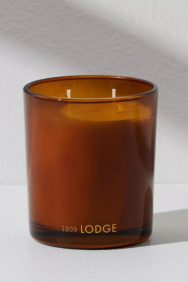 a brown candle sitting on top of a white table