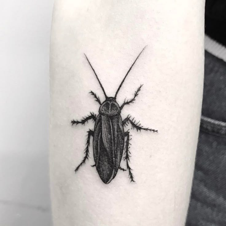 a black and white photo of a bug on the arm