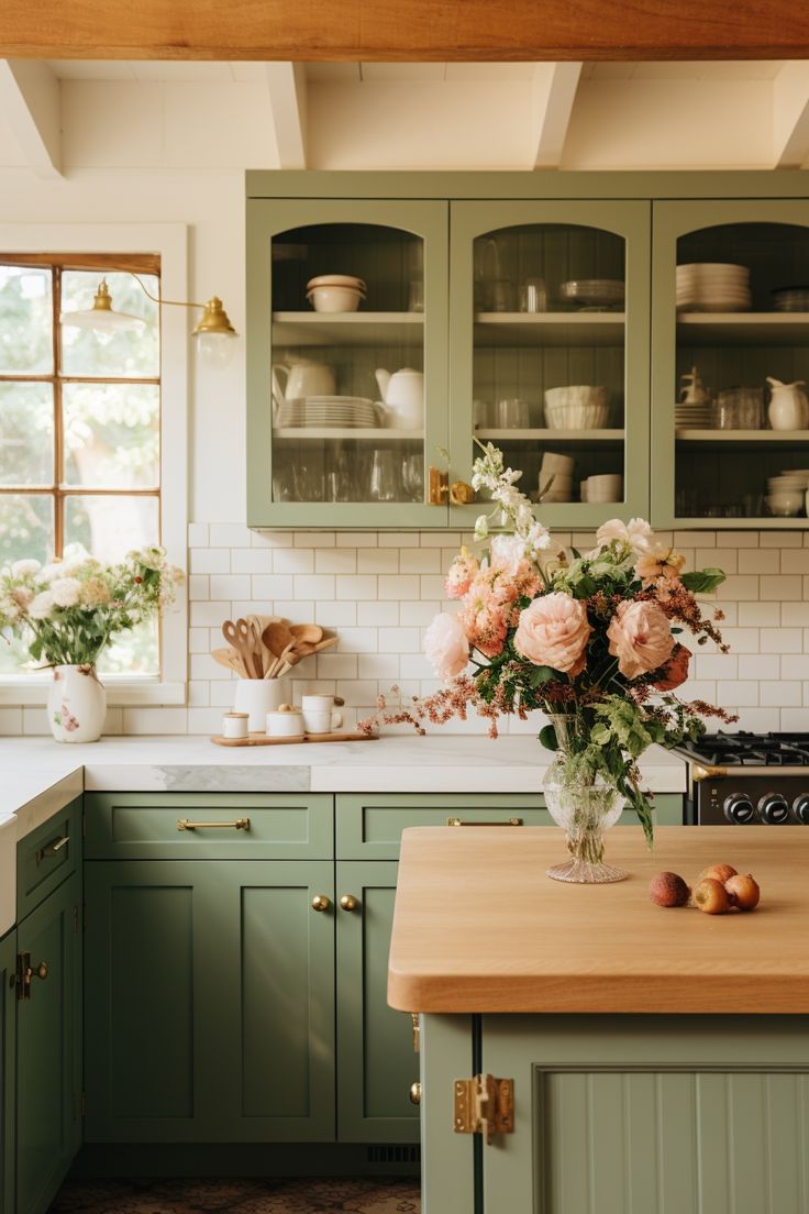 a vase filled with flowers sitting on top of a kitchen counter