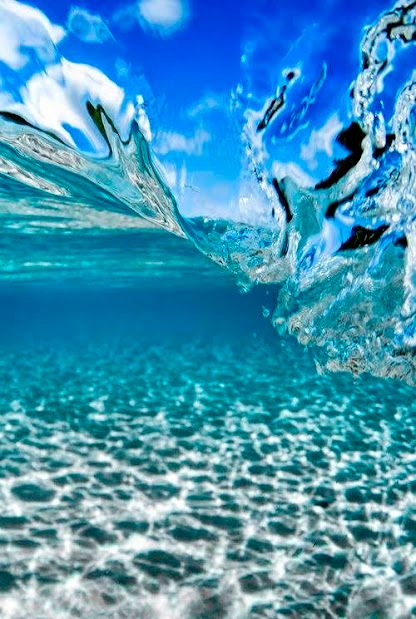 an underwater view of the ocean with clear water