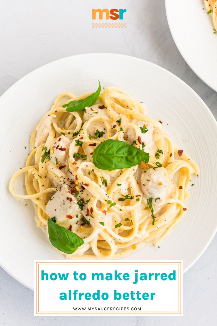 a white plate topped with pasta covered in sauce and garnished with green leaves