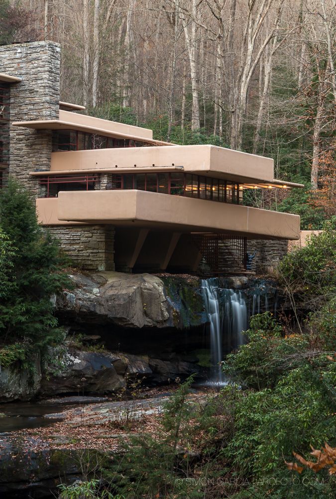 the falling house is built on top of a cliff in the woods near a waterfall