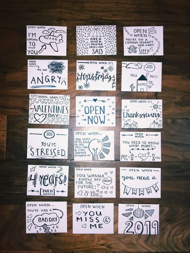 many different types of greeting cards are arranged on a wooden surface with the words happy new year written across them