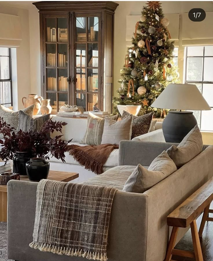 a living room filled with furniture and a christmas tree