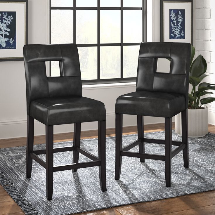 two black barstools in front of a window with a rug on the floor