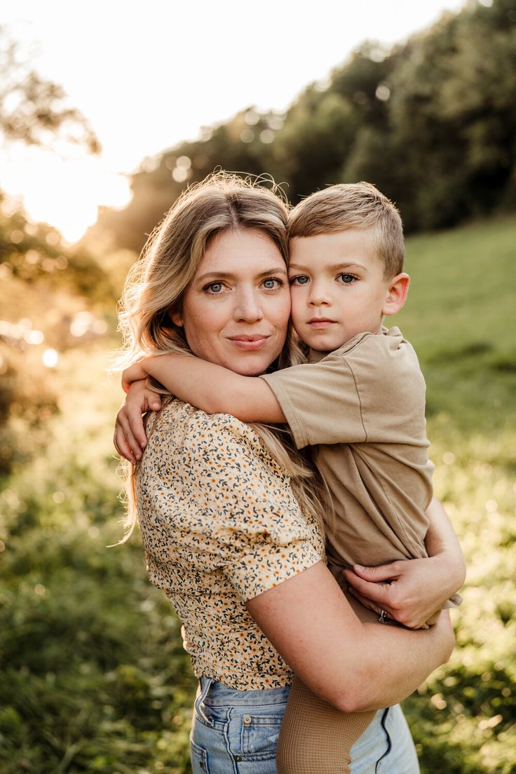 a woman holding a small boy in her arms