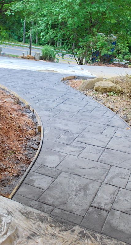 a brick walkway in the middle of a park