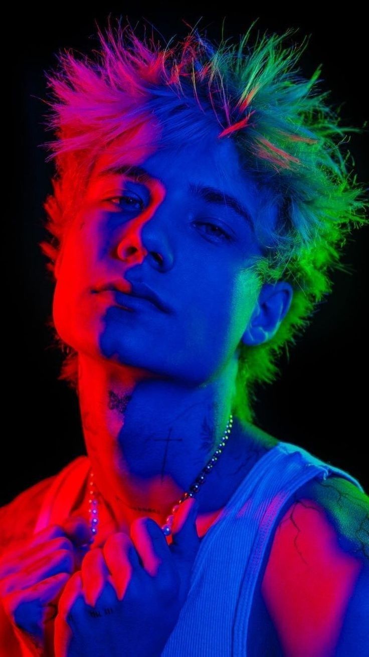 a young man with colorful hair and piercings