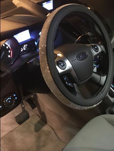 the interior of a car with a steering wheel cover