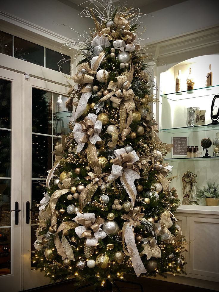 a decorated christmas tree with gold and silver ornaments