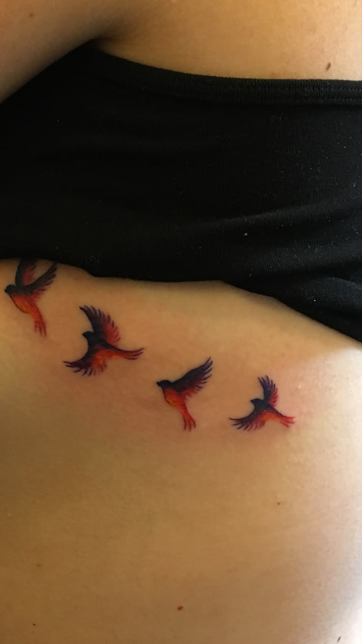 a woman's stomach with three birds on it