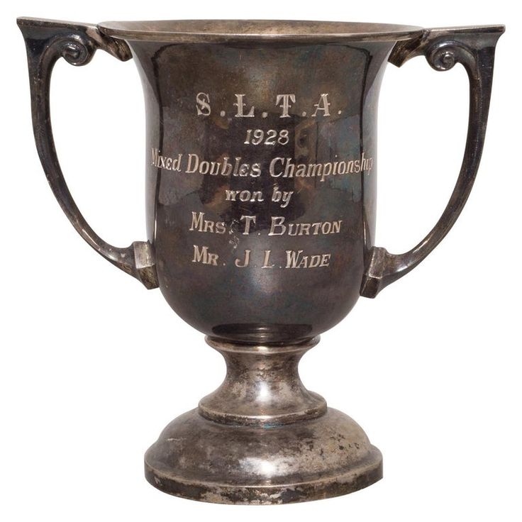 an old silver trophy with the names of two athletes on it's pedestals