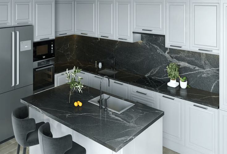 a kitchen with marble counter tops and stainless steel appliances, along with two bar stools