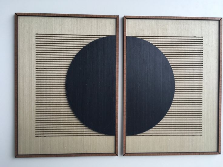 two framed paintings with black circles on them