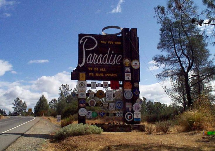 there is a sign that says paradise on the side of the road