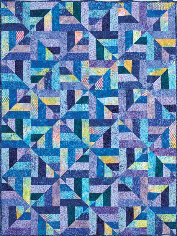 a quilt made with blue and yellow squares