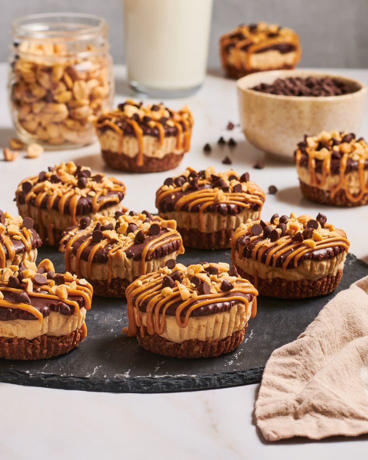 several desserts with chocolate chips and peanut butter drizzled on them