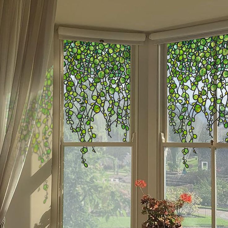 a vase with flowers in it sitting next to two large windows that have stained glass designs on them