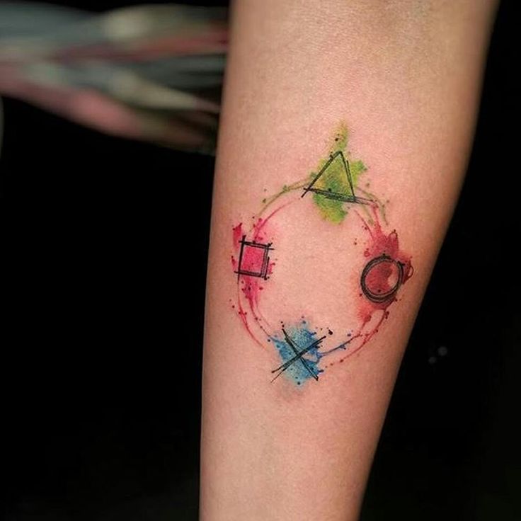 a colorful tattoo on the leg of a woman's left arm with an abstract design