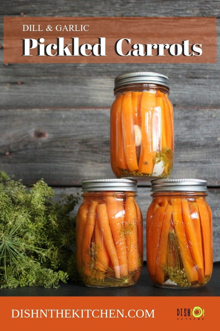 three jars filled with pickled carrots on top of a table