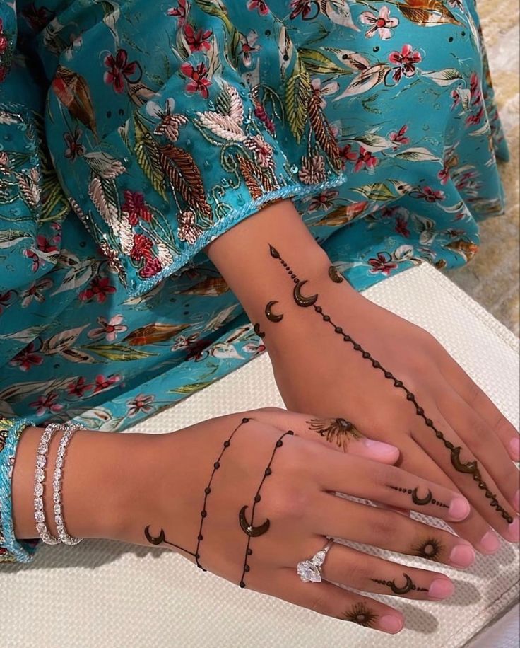 a woman's hands with tattoos on them