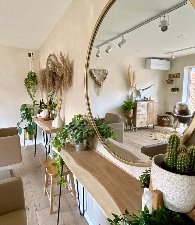 a living room filled with furniture and a large round mirror