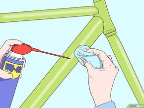 someone painting a bike frame with green paint