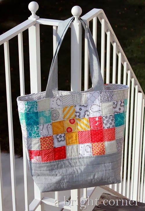 a handbag hanging on the side of a white railing