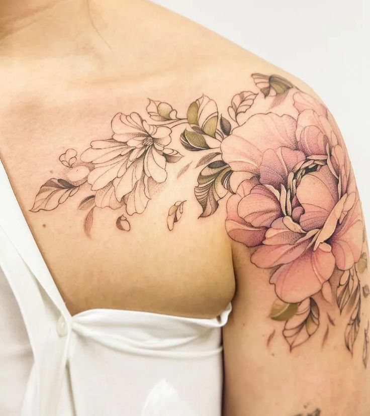 a woman with a flower tattoo on her shoulder