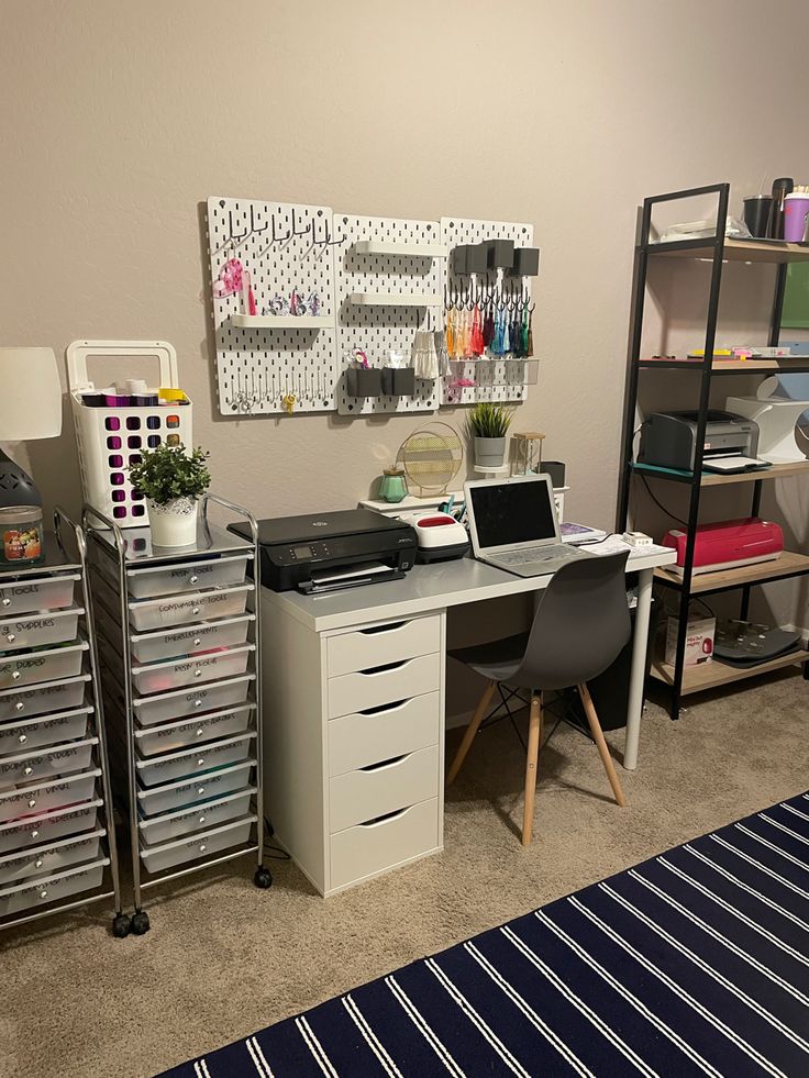 a room with a desk and shelves filled with crafting supplies