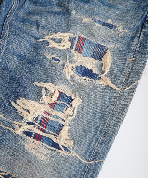 an old pair of jeans with torn edges