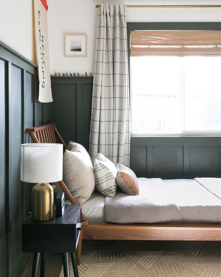 a bed sitting next to a window in a bedroom