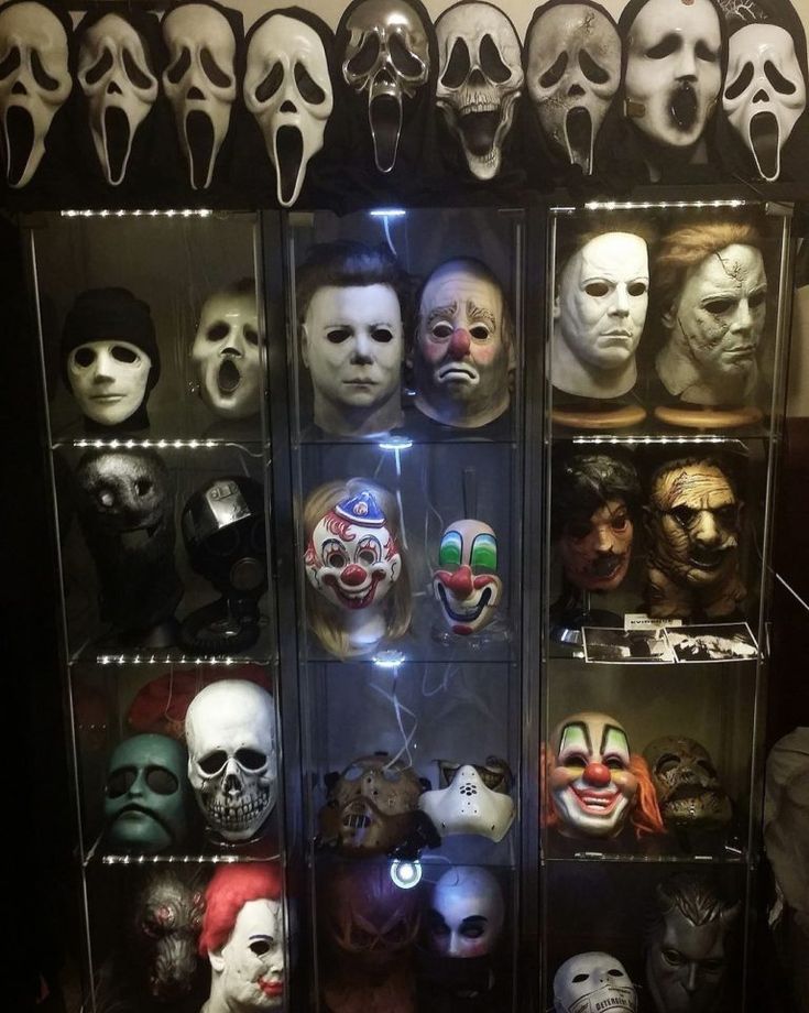 a display case filled with lots of creepy masks