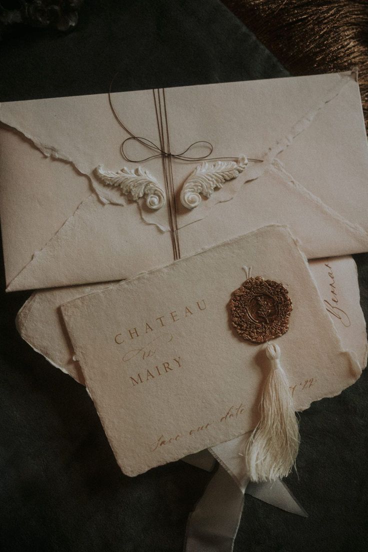 an envelope with a tassel on top of it and the words chateau de mark