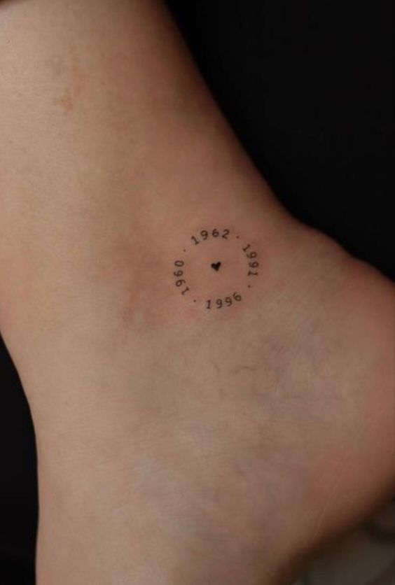 a woman's foot with a small clock tattoo on her left side ribcage