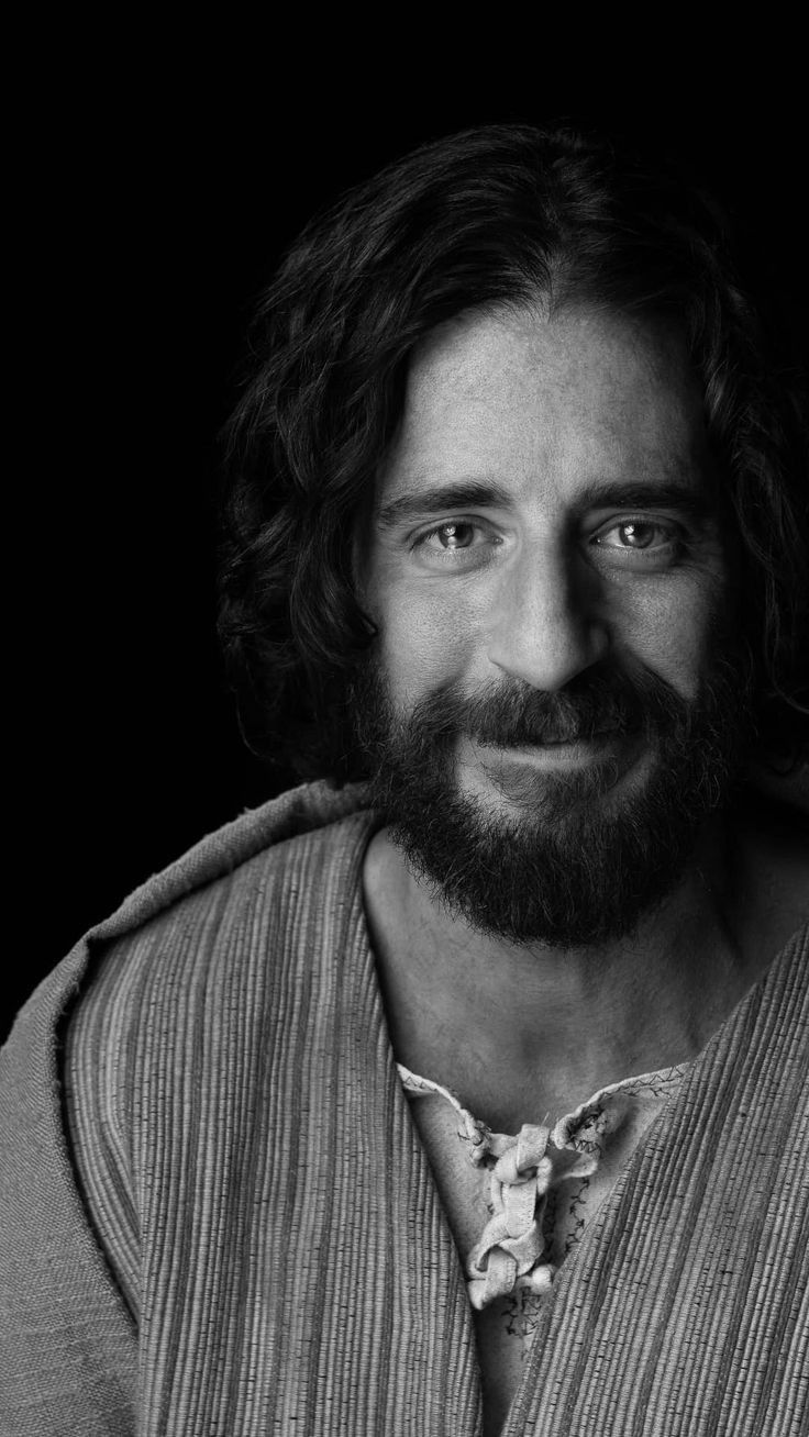 a black and white photo of a man with long hair