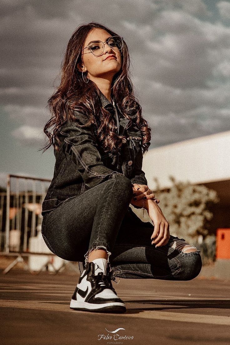 a woman sitting on the ground with her legs crossed