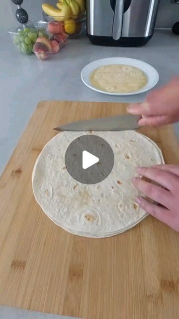 a person is making tortillas on a cutting board