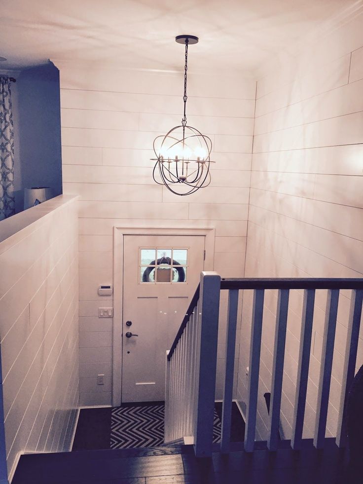 an instagram page on pinterest showing the entry way to a house with white walls and wood floors