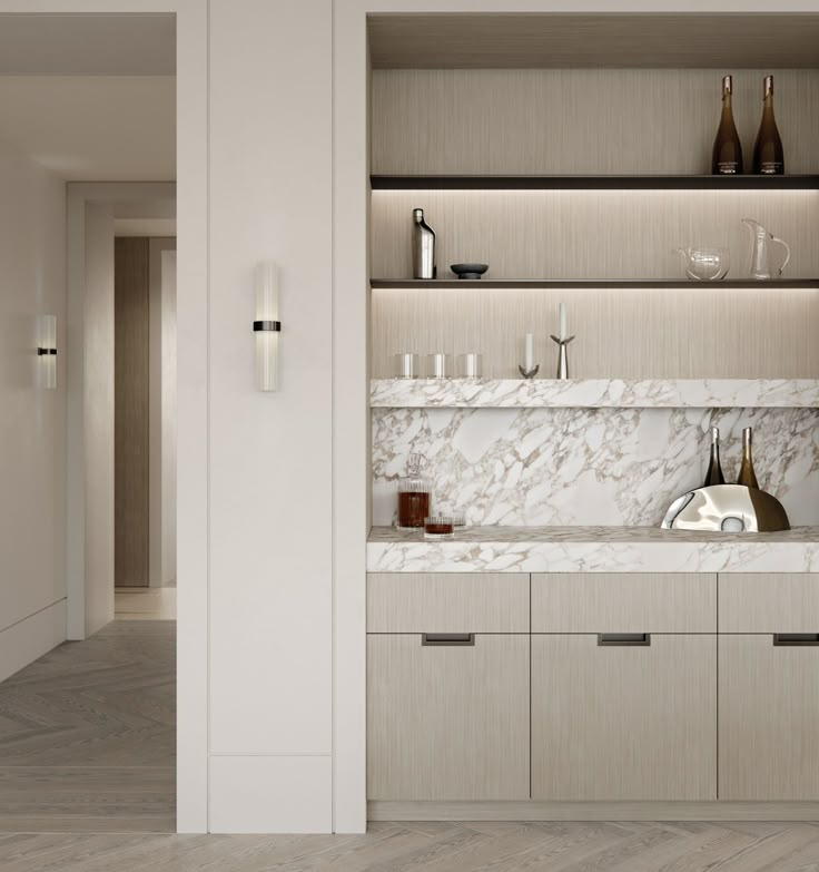 a kitchen with marble counter tops and white cabinets