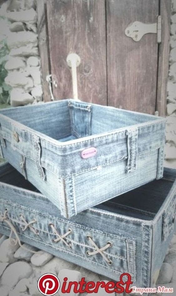 two denim boxes are stacked on top of each other in front of a stone wall