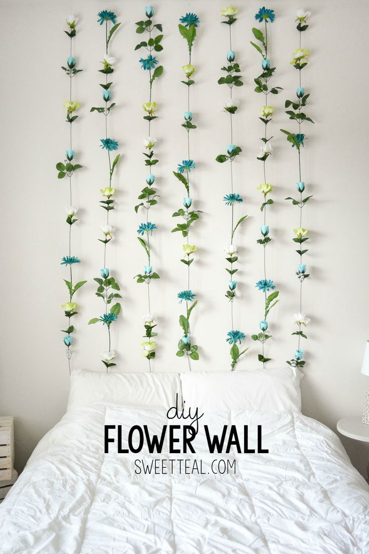 the flowers are attached to the wall above the bed