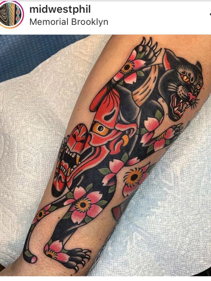 a person with a cat tattoo on their arm