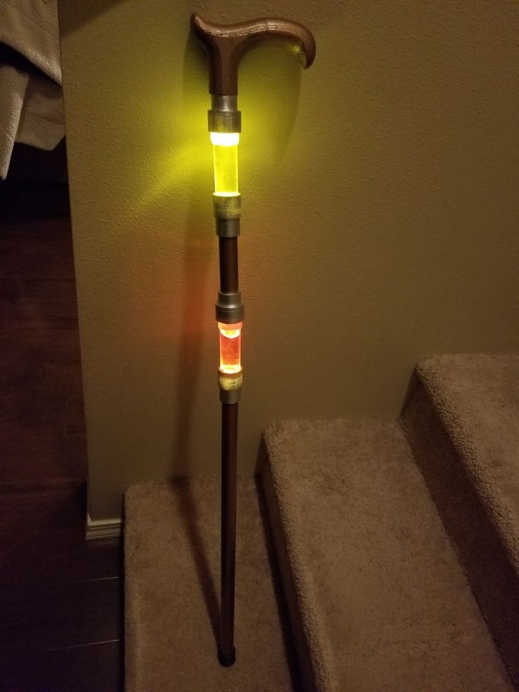 an illuminated cane is sitting on the stairs